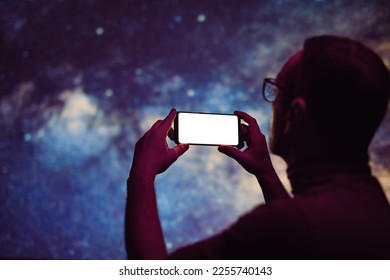 Astronomer photographing Milky Way night sky with a modern smartphone. - Powered by Shutterstock