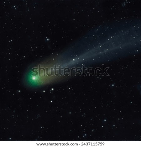 Astrophoto of periodic comet 12P Pons Brooks in the night sky. Green nucleus and tail of ion, dust and 