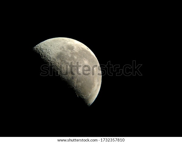 Astrophotography, half\
earth moon in the night\
sky