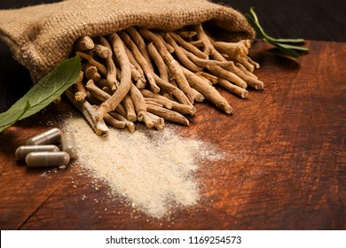 Aswagandha root on wooden table. Herbal adaptogen medicine.