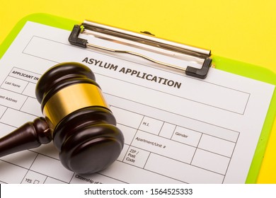 Asylum concept showing an application form for asylum on a yellow background with a gavel