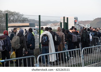 Asylum seekers wait to leave the Jungle camp, Calais, France. October 2016.