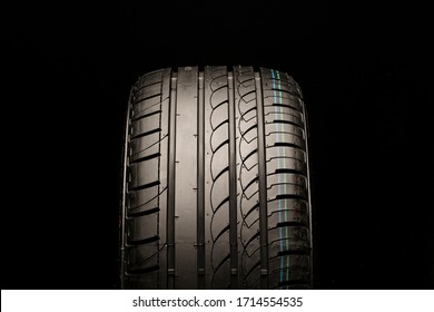 asymmetric summer tire. front view, close-up on a black background