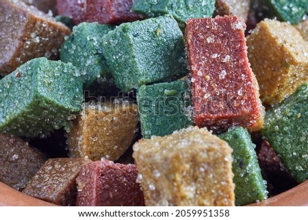 Ate is a typical Mexican sweet. Squares of ate of different fruits with sugar on a white background.