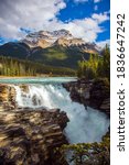 Athabasca Falls. Rocky Mountains of Canada. Mountains, rivers and waterfalls make up magnificent landscapes. The Columbia Glacier in Jasper Park. Travel, ecological and photo tourism concept