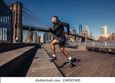Athelte man running in New York City street wearing sport clothes