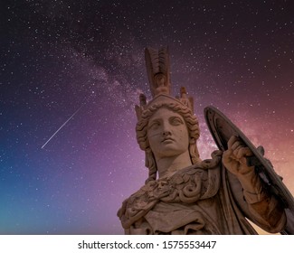 Athena the ancient Greek goddess statue under dramatic night sky, Athens Greece