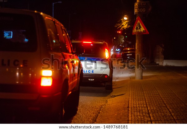 Athens, Acharnai-Menidi /Greece August 28\
2019: Night outdoor Greek police car on road \
