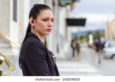 ATHENS, ERMOU,GREECE FEBRARY 5 2016: Highly Trained Female Bodyguard With Headset Look Around 