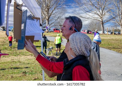 Athens, Georgia - January 1, 2020: Runners Check Race Times At The End Of The New Years At Noon 5k Road Race.