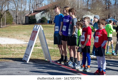 Athens, Georgia - January 1, 2020: Young Runners In Position Await The Start Of The New Years At Noon 5k Road Race.