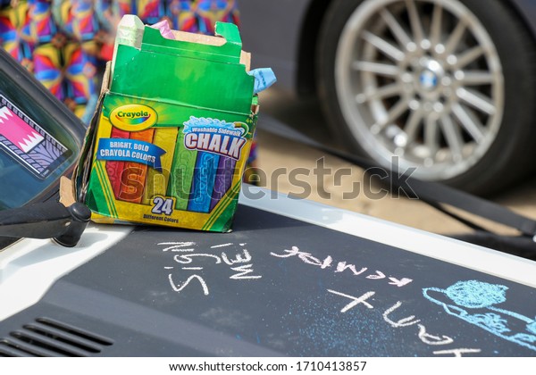 Athens, Georgia - July 01, 2017: Chalk on\
the hood of a vintage Volkswagen painted with blackboard paint sits\
next to an invitation to sign the car at the monthly gathering of\
classic car\
enthusiasts.