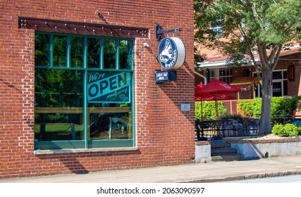 Athens, Georgia - June 12, 2020: During The COVID-19 Pandemic, Hendershot’s, A Popular Live Music Venue, Displays A Large Sign In Its Front Window Announcing It Is Open For Business.