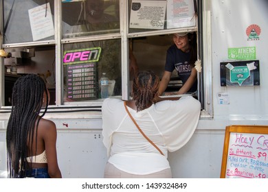 Athens, Georgia - June 22, 2019: A Woman Places An Order At The Window Of A Food Truck During The AthFest Music And Arts Festival.