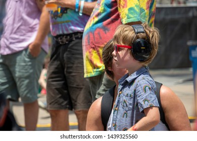 Athens, Georgia - June 22, 2019: A Young Boy Wears Hearing Protection While Listening To A Live Music Performance At The AthFest Music And Arts Festival.