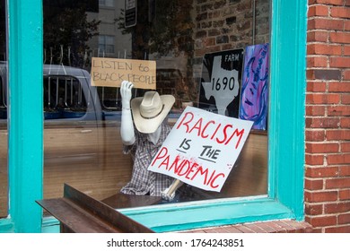 Athens, Georgia - June 25, 2020: A Seated Mannequin In A Cowboy Hat Holds Hand-drawn Anti-racist Signs In The Front Window Of The World Famous, A Downtown Eatery And Music Venue.