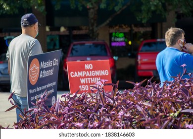 Athens, Georgia - October 16, 2020: Signs Remind Voters Waiting In Line About Polling Place Restrictions And The Wearing Of Protective Face Masks During Early Voting For The November General Election.