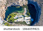 Athens Greece Aerial drone view of Vouliagmeni lake, thermal mineral water with healing abilities, luxury health spa, sunny summer day.