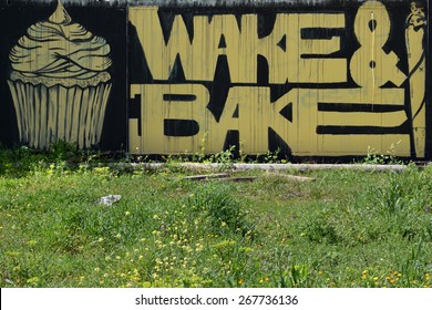 ATHENS, GREECE - APRIL 6, 2015: Cupcake and cannabis rolled cigarette graffiti with wake and bake slogan slang for smoking marijuana for breakfast.