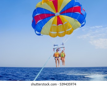 Athens, Greece - august 28, 2011: Parasailing in a blue sky in Santorini beach. Parasailing is a popular recreational activity there. This is one of the most beautiful Islands on the planet.