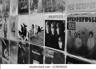 ATHENS, GREECE - AUGUST 29, 2018: Wall with vintage vinyl records pop and rock music album sleeves background. Selective focus black and white.