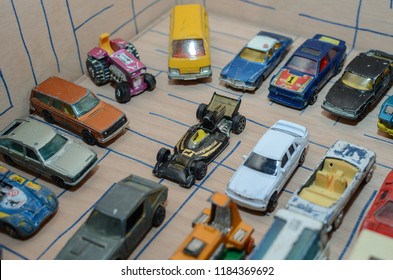 Athens, Greece – December 15, 2016: Old Matchbox Toy Cars Of The 70’s, Parked On A Wooden Deck With The Pattern Of A Labyrinth, Designed With A Blue Pen.