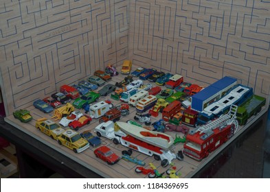 Athens, Greece – December 15, 2016: Old Matchbox Toy Cars Of The 70’s, Parked On A Wooden Deck With The Pattern Of A Labyrinth, Designed With A Blue Pen.