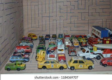 Athens, Greece – December 15, 2016: Old Matchbox Toy Cars Of The 70’s, Parked On A Wooden Deck With The Pattern Of A Labyrinth, Designed With A Blue Pen.