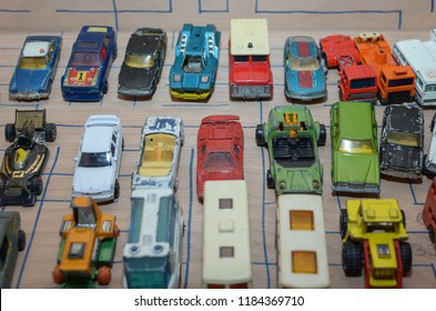 Athens, Greece – December 15, 2016: Old Matchbox Toy Cars Of The 70’s, Parked On A Wooden Deck With The Pattern Of A Labyrinth, Designed With A Blue Pen.