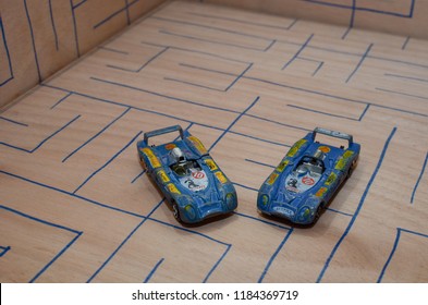 Athens, Greece – December 15, 2016: Old Matchbox Toy Cars Of The 70’s, Parked On A Wooden Deck With The Pattern Of A Labyrinth, Designed With A Blue Pen.