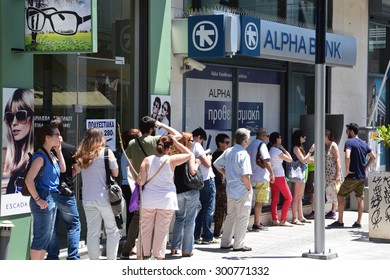 ATHENS, GREECE - JULY 1, 2015: Long Line Of People Waiting To Withdraw Cash Money From ATM Cashpoint Outside A Closed Bank. Capital Controls During Greek Financial Crisis.