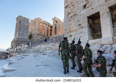 Athens, Greece - July 26, 2021: The acropolis, most famous citadel in the world on the hills of Athens.  One of the most visited travel destinations. Morning changing of the guard with flag hoisting