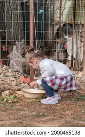 Athens, Greece - June 24, 2021: Young Girl Collecting Eggs At A Small Family Farm.