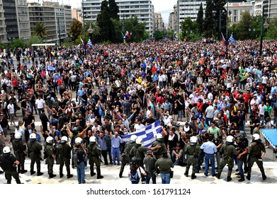 ATHENS, GREECE -MAY, 05: Protesters, with Greek flags, demonstrate against government austerity measures, outside the Greek Parliament in Syntagma Square Athens, May 05, 2010. 