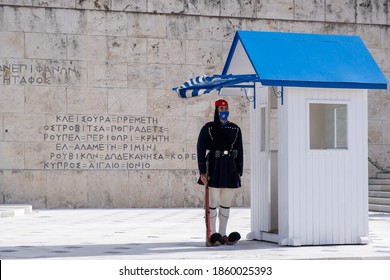 Athens Greece, November 19, 2020. Presidential Guard Tsolias Wearing A COVID 19 Protective Face Mask, Standing Infront Of Greek Parliament Building. Tourist Attraction At Coronavirus Days.