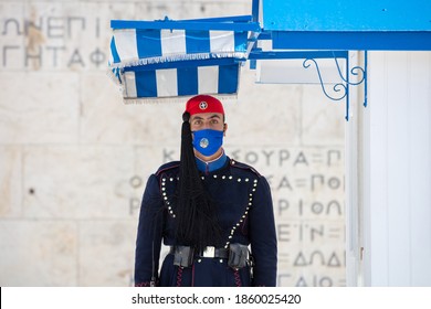 Athens Greece, November 19, 2020. Presidential Guard Tsolias Evzonas Wearing COVID 19 Protective Face Mask Infront Of Greek Parliament Building. Tourist Attraction At Coronavirus Days.