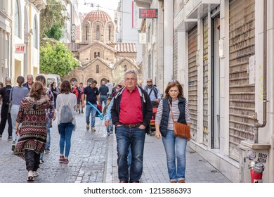 Athens, Greece - October 14, 2018: People Sightsee At The Church Of Panagia Kapnikarea, A Famous Landmark In The Monastiraki Neighborhood, A Popular Tourist Area In Central Athens.