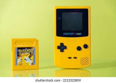 Athens Greece October 2 2022. Yellow Game Boy Color Handheld Game Console, With A Yellow Cartridge On A Yellow Background With Reflection