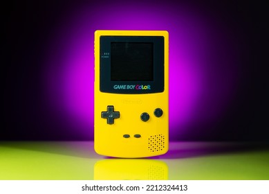 Athens Greece October 2 2022. Yellow Game Boy Color Handheld Game Console, On A Purple Background With Reflection