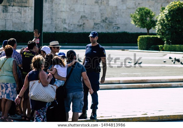 Athens Greece September 1, 2019 View of Greek\
police officer standing front the tomb of the Unknown Soldier in\
Athens in the morning