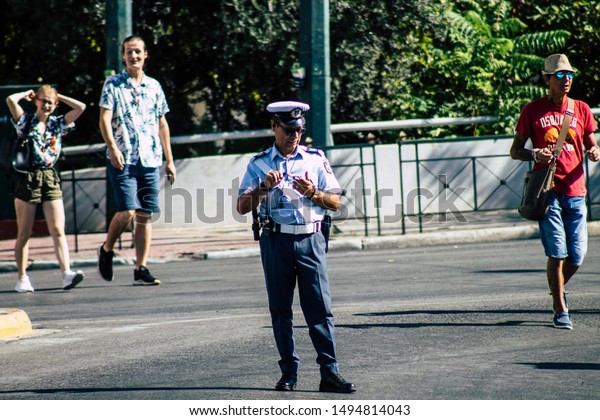 Athens Greece September 1, 2019 View of Greek\
police officer standing front the tomb of the Unknown Soldier in\
Athens in the morning