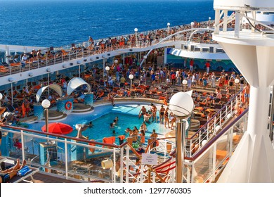 Athens, Greece - September 18 2018: Tourists Lounge In The Sun, Swim And Party On The Upper Deck Of A Large Cruise Ship