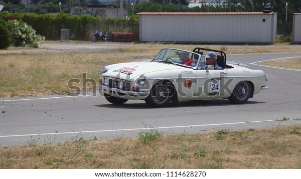 ATHENS, JUNE\
10, 2018. Classic english car MG B, of 1965, during a circuit run\
close to Athens, participating in the HERO Classic Marathon Rally,\
held in Greece from 10-16, June\
2018