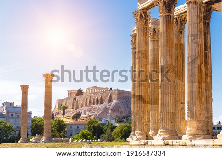 Athens view, Zeus temple overlooking Acropolis, Greece. Ancient Greek ruins, famous landmarks of Athens city. Scenery of great columns of classical building in Athens center. Travel in Greece theme.