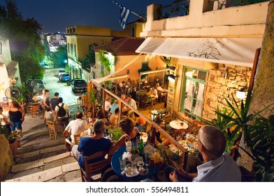 ATHENS-AUGUST 22: Street with various restaurants and bars, locals and tourists enjoy their meal at night on Plaka area, on August 22, 2014 in Athens,
