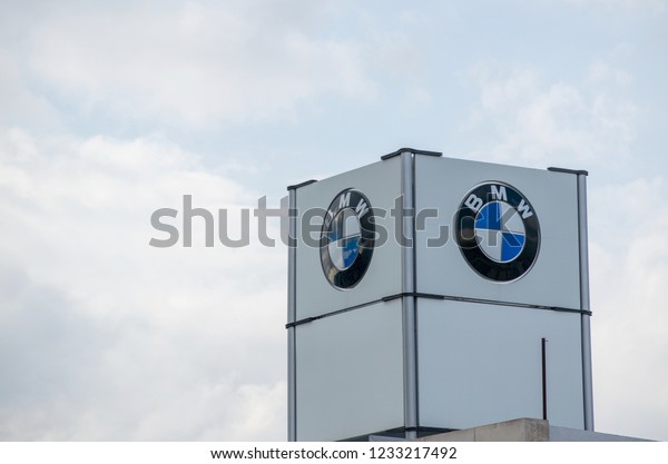 Athens,Greece-November\
17,2018.Logo of the BMW car company at a metal structure with a\
cloudy sky\
background.