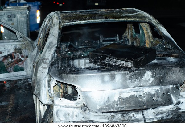 Athens,Menidi Acharnes/ Greece - May 11\
2019:burning car and cash drawer after\
robbery