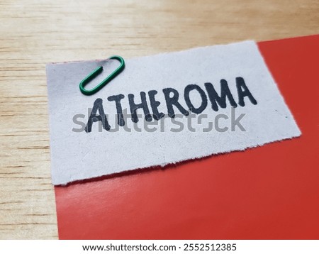 Atheroma wtitting on table background.