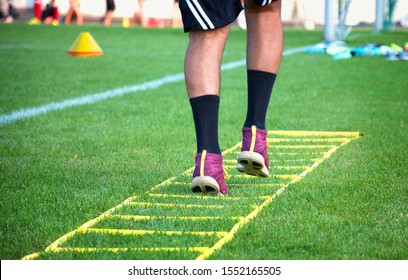 Athlet Feet On Agility Speed Ladder Improving Fitness In Drill On Lawn