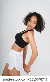 Athlete African Woman Curly Hair In Black Sport Bra On White Background.